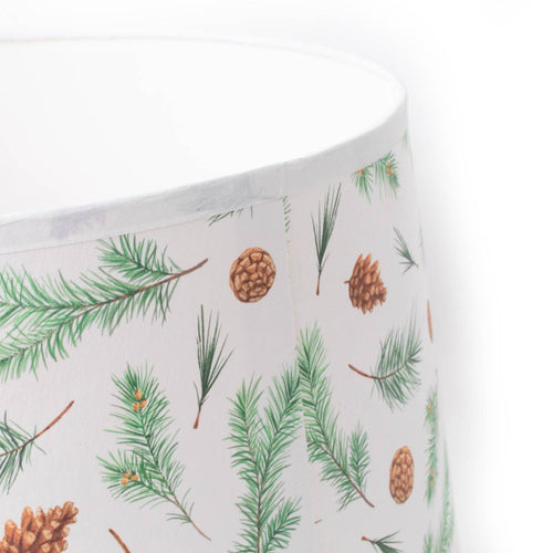 Close-up of a handcrafted parchment lamp shade featuring a pine bough and pine cone pattern, designed to softly diffuse light in Lamps & Lighting, Lamp Shades, Parts and Accessories, and Best Sellers collections.