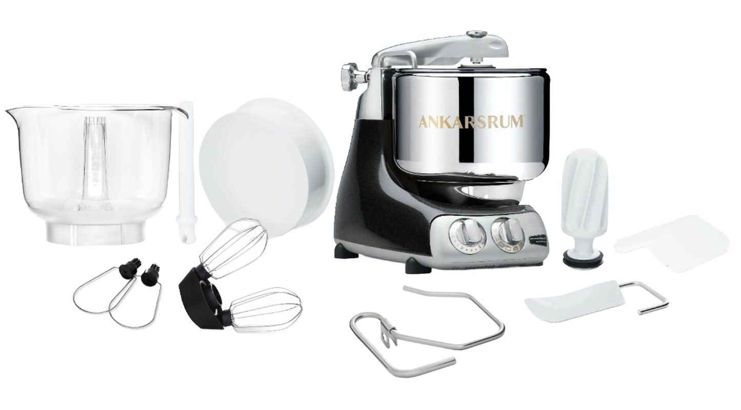 Ankarsrum Assistent Original stand mixer in black with stainless steel mixing bowl and various attachments displayed on a white surface, ideal for Kitchen & Food and Baking Supplies collections.