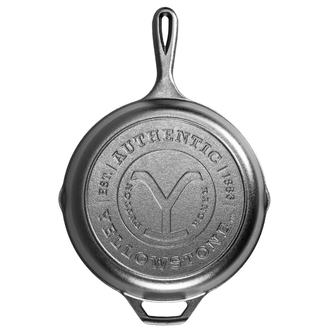 Top view of a handcrafted cast iron skillet featuring a stamped "Authentic Yellowstone" emblem, made in USA, ideal for Kitchen & Food and Cast Iron cookware collections.