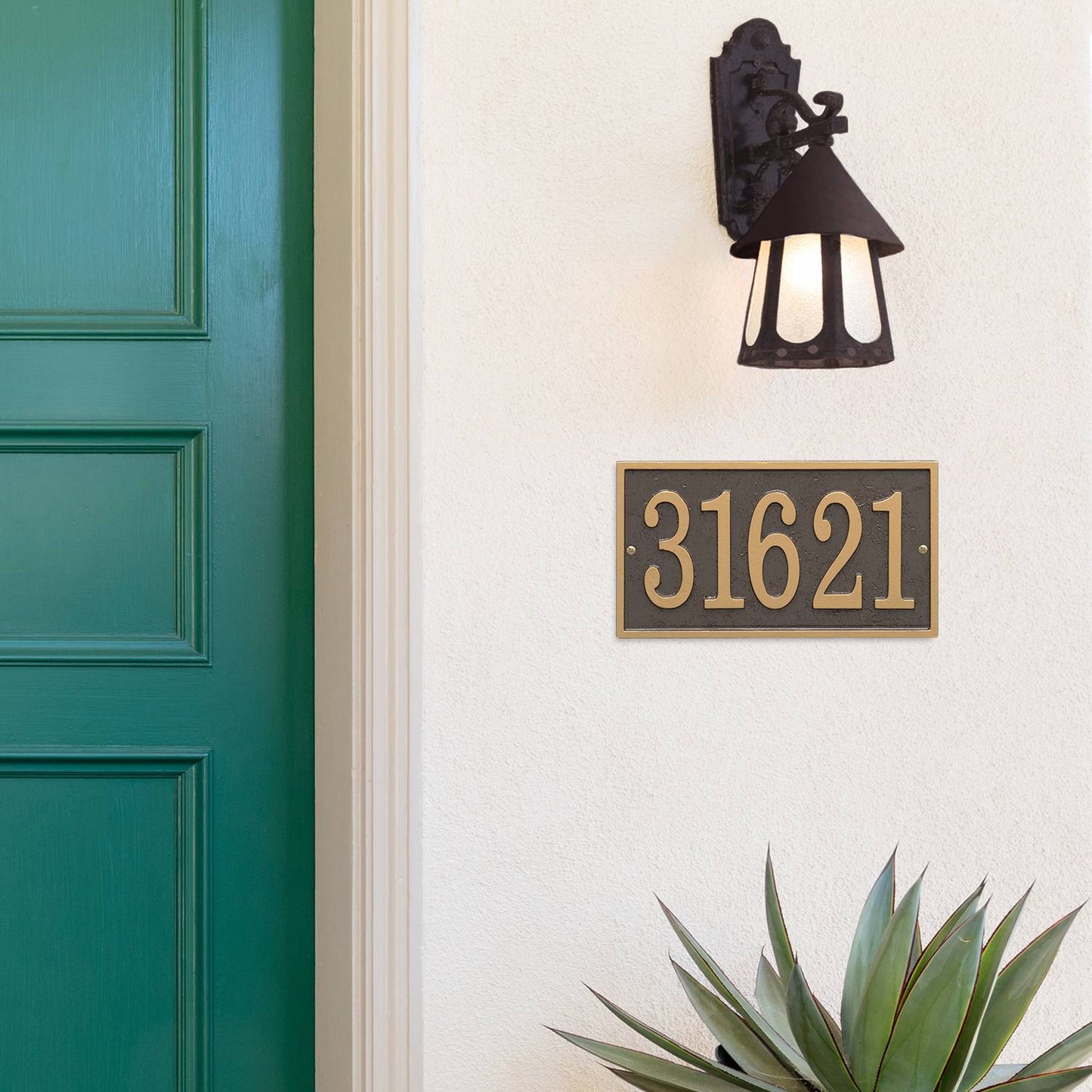 Elegant bronze and gold rectangular custom address plaque mounted on white exterior wall below a rustic black outdoor lantern, enhancing curb appeal in Home & Decor and USA Made collections.
