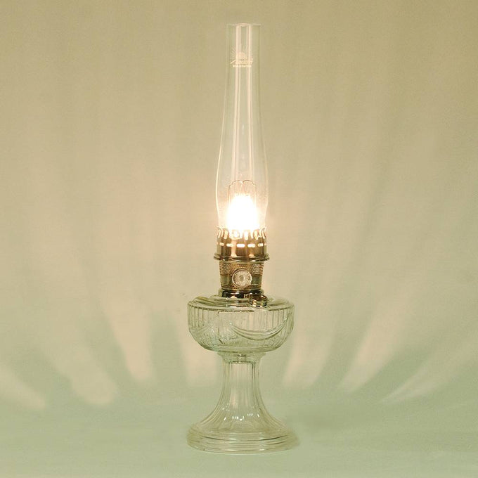 Handcrafted clear glass oil lamp with polished brass burner and tall chimney featuring an elegant drape pattern, made in USA, part of Lamps & Lighting, Oil Lamps, Table Lamps, Best Sellers, Promo Eligible collections.