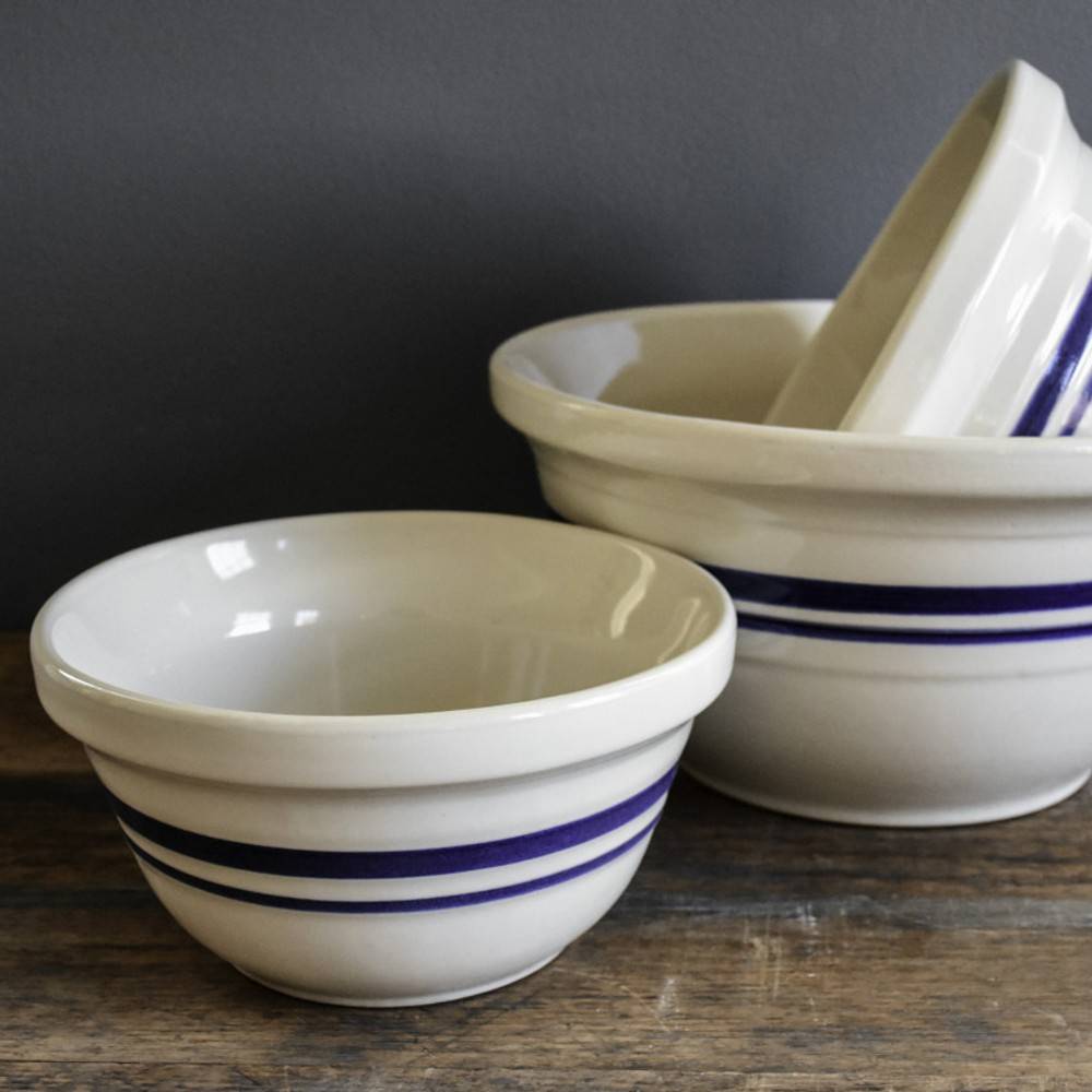 Set of handcrafted cream stoneware mixing bowls with deep blue stripes, made in Ohio, USA, ideal for Kitchen & Food, Cookware, Baking Supplies, Storage and Serving, and Best Sellers collections.