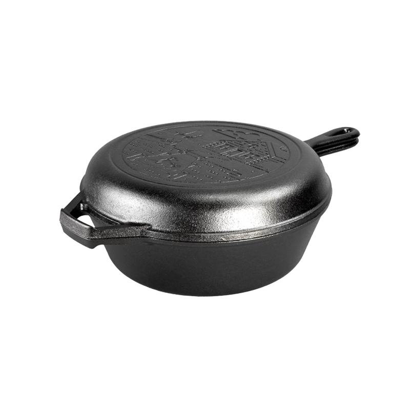 Black cast iron combo cooker featuring a rustic cabin scene imprinted on the lid, designed for camping and kitchen use, handcrafted and made in the USA.