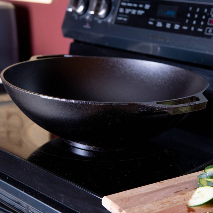 Seasoned cast iron wok with wide base and deep sides, designed for superior heat retention and balanced cooking, featured in Kitchen & Food, Cast Iron, and USA Made collections.