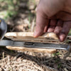 Handheld wooden handle with ergonomic grooves for secure grip attached to wrought iron pan, featured in Farm, Garden & Tool, Kitchen & Food, Camping, Cookware, and Pots and Pans collections.