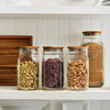 Set of three handcrafted acacia wood lids fitted on wide mouth glass jars filled with dry pantry ingredients, highlighting airtight storage in Kitchen & Food and Storage and Serving collections.