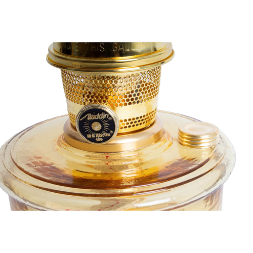 Close-up of the top portion of a handcrafted amber glass wall oil lamp with a polished brass burner and wick adjustment knob, ideal for lamps and lighting, emergency supplies, and farm tool collections.