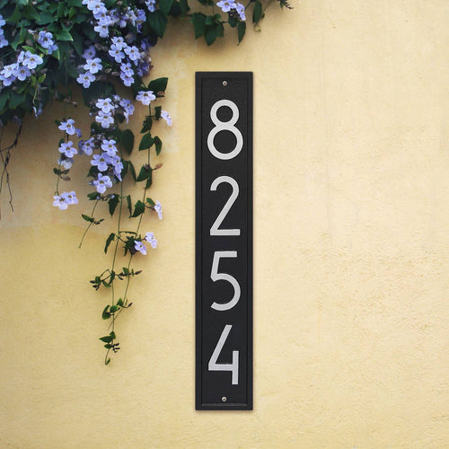 Handcrafted vertical custom address plaque in black with silver numbers in a sleek modern font mounted on a light yellow stucco wall, enhancing curb appeal for Home & Decor, Household Helpers, Mailboxes and Address Signs, USA Made, and Best Sellers collections.