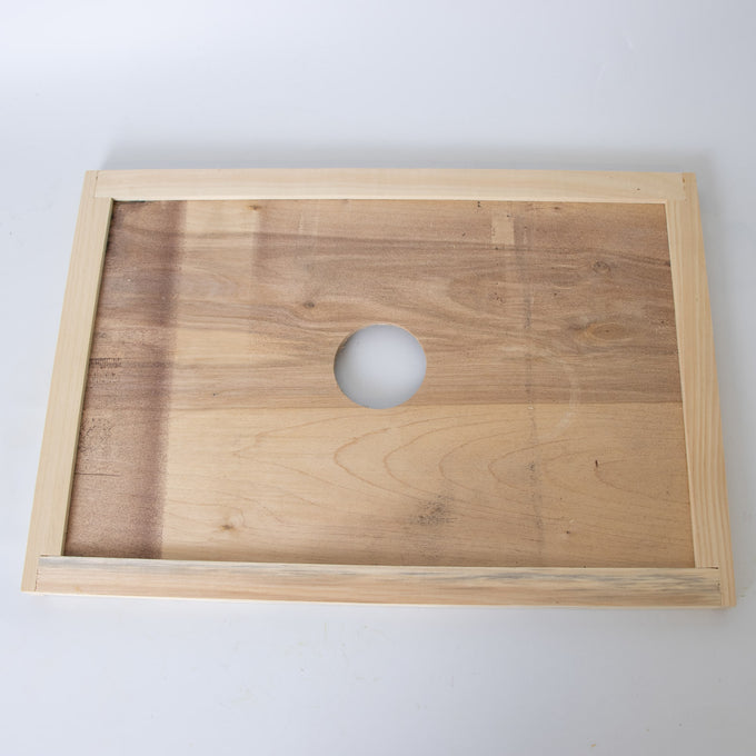 Handcrafted wooden hive inner cover with a 2-3/4" center hole for ventilation, made in USA by Amish artisans, ideal for beekeeping and 8-frame hive components collections.
