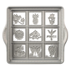 Cast aluminum baking pan with decorative embossed designs including bird, pineapple, flower, and butterfly, featuring rope borders, handcrafted in USA, ideal for kitchen and baking supplies collections.