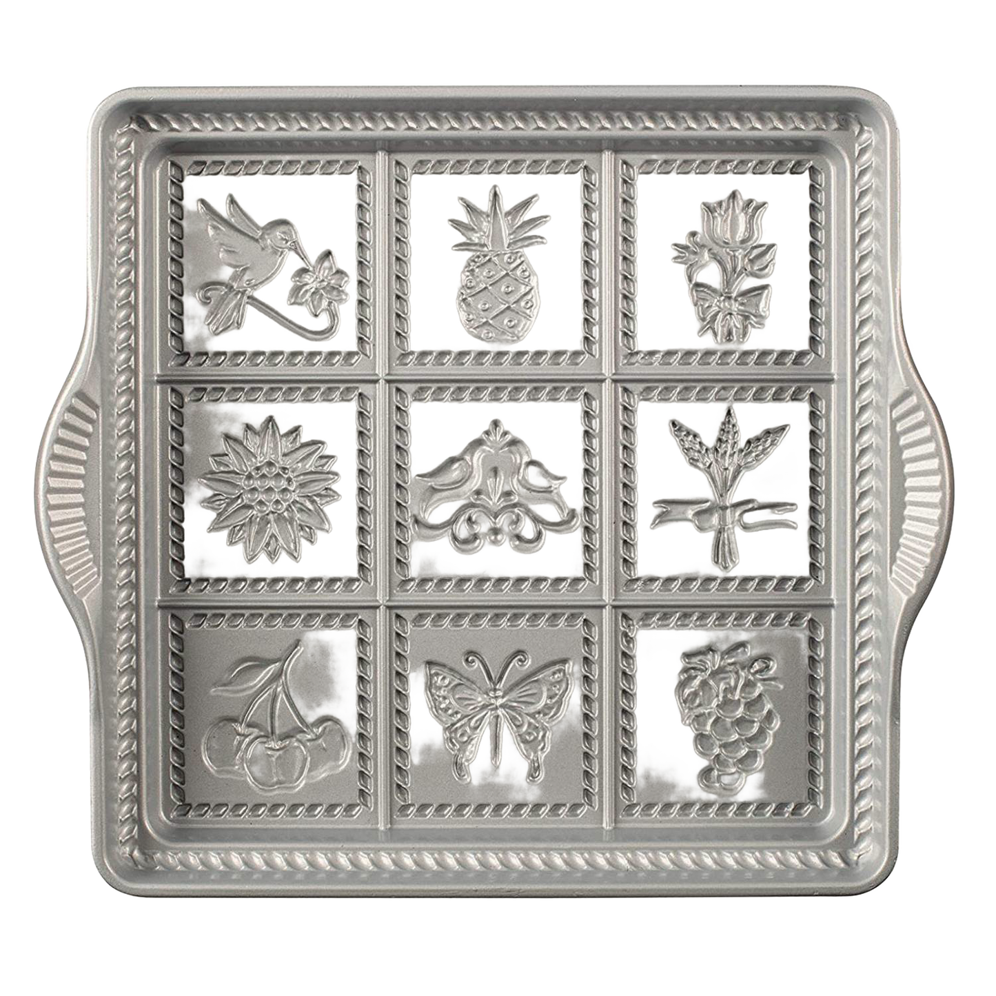 Cast aluminum baking pan with decorative embossed designs including bird, pineapple, flower, and butterfly, featuring rope borders, handcrafted in USA, ideal for kitchen and baking supplies collections.