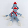 Handcrafted blue and white hand-sewn sock monkey wearing a red pom-pom hat and ribbon bow, made in USA, featured in Toys, Books & Games, Children's Toys, Indoor Play, and Best Sellers collections.