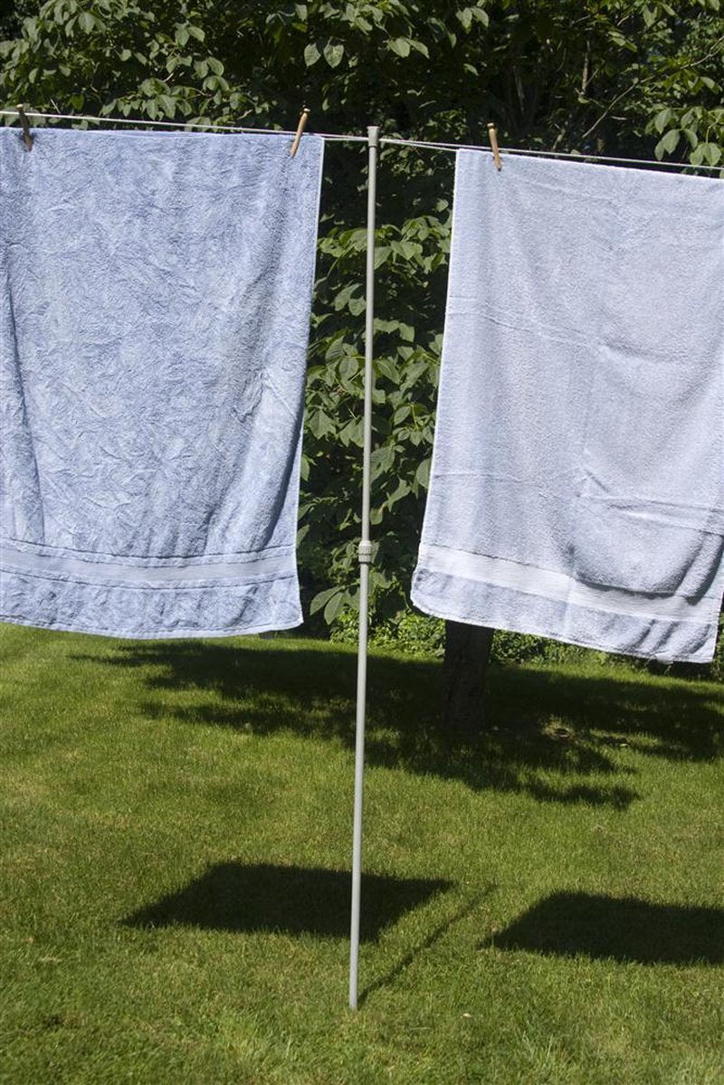 Lightweight steel clothesline prop with plastic end cap supporting a taut clothesline holding large towels outdoors, ideal for Home & Decor and Laundry Supplies collections.