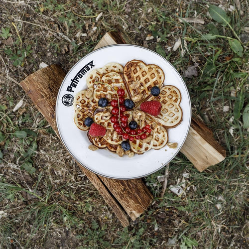 White enamel plate with black rim and Petromax logo holding heart-shaped waffles topped with fresh raspberries, blueberries, red currants, and walnuts, perfect for outdoor dining in Farm, Garden & Tool, Kitchen & Food, Camping, Dinnerware, Best Sellers, and Promo Eligible collections.