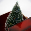 Close-up of handcrafted lighted green holiday tree with white frosted tips and tiny colorful lights, featured in Home & Decor, Holiday Decor, and Best Sellers collections.
