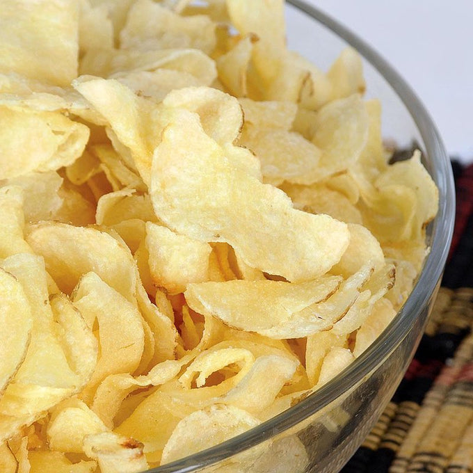 Clear glass bowl filled with light, crunchy golden potato chips, perfect for snack lovers in Kitchen & Food, Snacks and Sweets, USA Made, and Best Sellers collections.