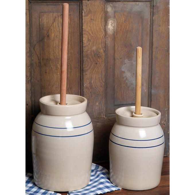 Pair of handcrafted stoneware butter churns in natural stone color with smooth unfinished wooden dashers and classic double blue stripes, made in USA, featured in Kitchen & Food, Specialty Equipment, Making Butter, USA Made, Best Sellers, and Promo Eligible collections.