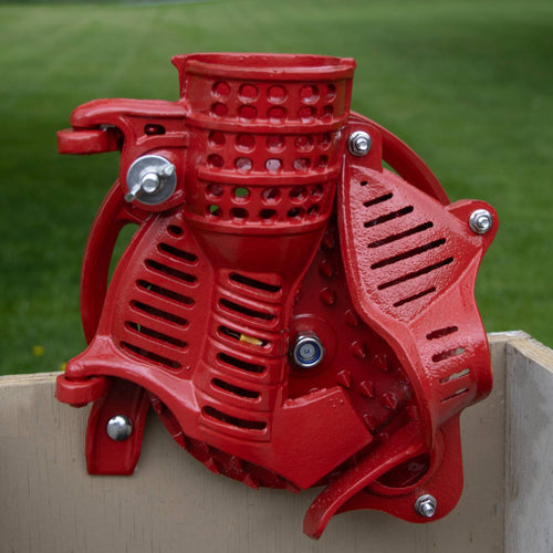 Handcrafted cast iron corn sheller in bright red with metal hardware, designed to quickly strip kernels; featured in Farm, Garden & Tool, Farm Tools, and Best Sellers collections.