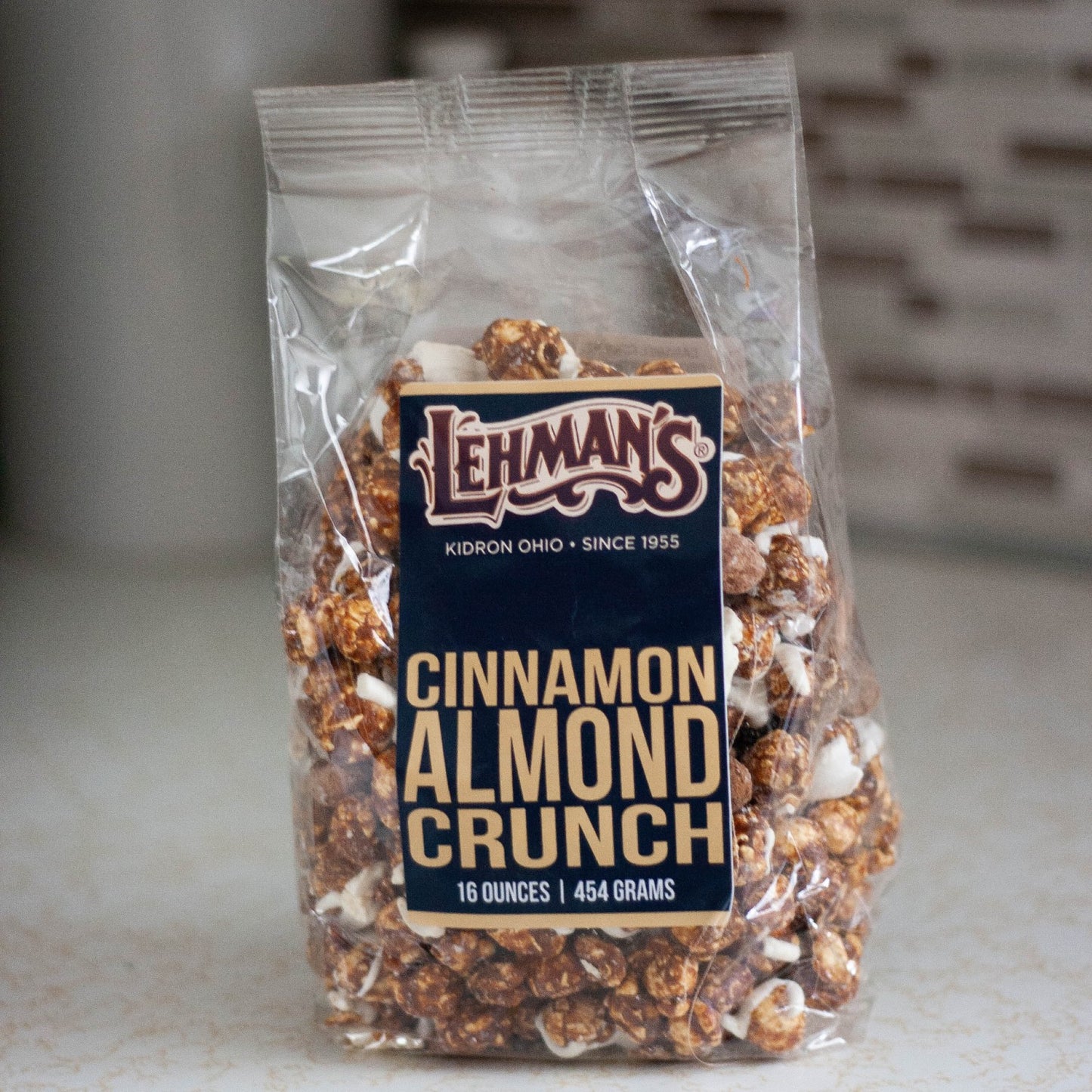 Clear bag of handcrafted cinnamon almond crunch popcorn, a sweet and crunchy snack made in USA, perfect for Kitchen & Food, Snacks and Sweets, Popcorn, USA Made, Best Sellers, and Promo Eligible collections.