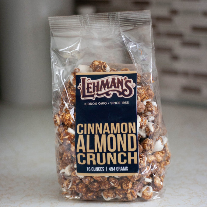 Clear bag of handcrafted cinnamon almond crunch popcorn, a sweet and crunchy snack made in USA, perfect for Kitchen & Food, Snacks and Sweets, Popcorn, USA Made, Best Sellers, and Promo Eligible collections.