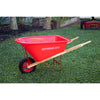Child’s wheelbarrow with solid wood handles, durable red poly bed, metal frame, and rubber tire set outdoors on grass, handcrafted for Toys, Books & Games and Lawn Games collections.