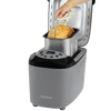 Hand removing freshly baked multigrain bread from a silver and black electric bread maker machine with digital controls, ideal for Kitchen & Food and Bread Making Supplies collections.