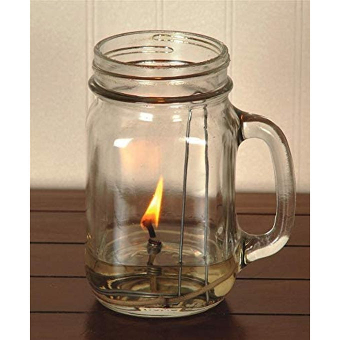 Glass pint jar lamp with lit cotton wick element burning a small flame, showcasing handcrafted parts for olive oil lamps in USA made lamps and lighting collections.