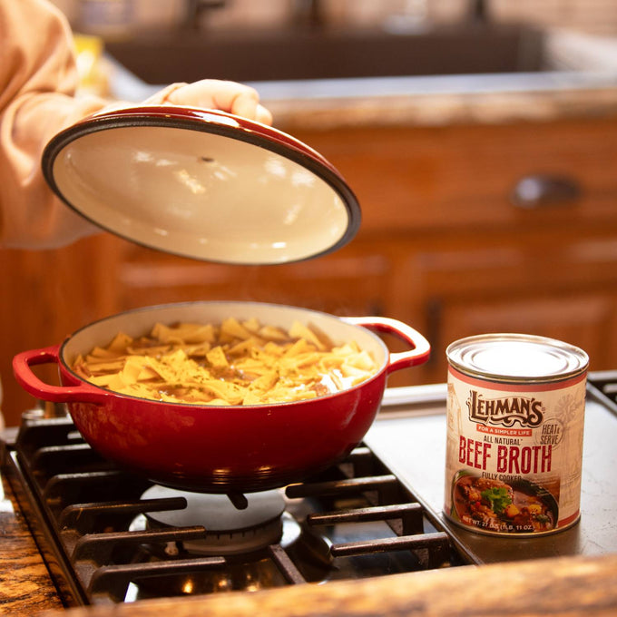Handcrafted Lehman’s canned beef broth next to a red pot simmering soup on a stove, ideal for Farm, Garden & Tool, Kitchen & Food, Emergency Supplies, Food, Meats, Best Sellers, and Promo Eligible collections.