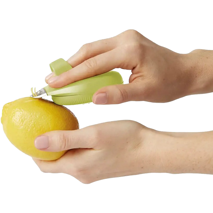 Handheld green PalmZester designed for comfortable zesting and peeling lemons, featuring an ergonomic grip and channel knife, ideal for Kitchen & Food and Cooking Helpers collections.