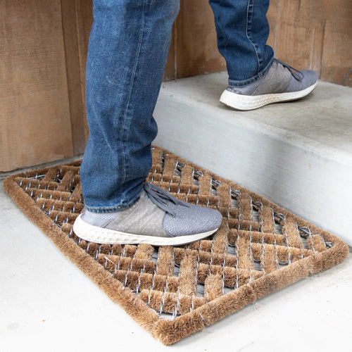 Footwear cleaning mat with natural coconut fiber bristles and wire brushes arranged in a durable herringbone pattern, handcrafted for tough dirt removal, featured in Home & Decor and Best Sellers collections.