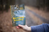 Person holding a handcrafted book titled Backyard Sugarin' featuring a metal sap bucket and tap image, ideal for Farm, Garden & Tool and Maple Syrup Sugaring Supplies collections.