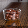 Clear glass bowl filled with handcrafted sugar-free milk chocolate covered peanuts, showcasing smooth glossy chocolate coating, perfect for Kitchen & Food and Snacks collections.