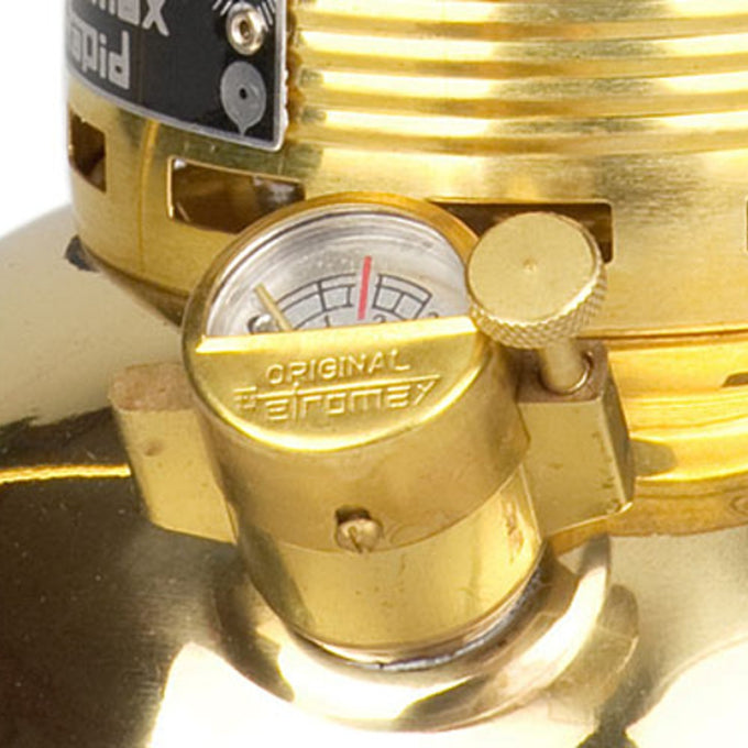 Close-up of a polished brass pressure gauge and control valve on a Petromax HK500 kerosene lamp, designed for bright, durable lighting in camping, farm, garden, and emergency settings.