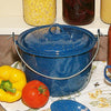 Royal Blue enamelware kettle with white speckled pattern and lid, featuring a sturdy metal handle, displayed alongside fresh vegetables on a kitchen counter, part of Farm, Garden & Tool and Kitchen & Food collections.