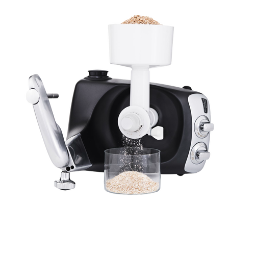 Black stand mixer with white grain mill attachment grinding fresh oats into a clear container on a clean surface, ideal for Kitchen & Food, Baking Supplies, Grain Mills, and Cooking Helpers collections.