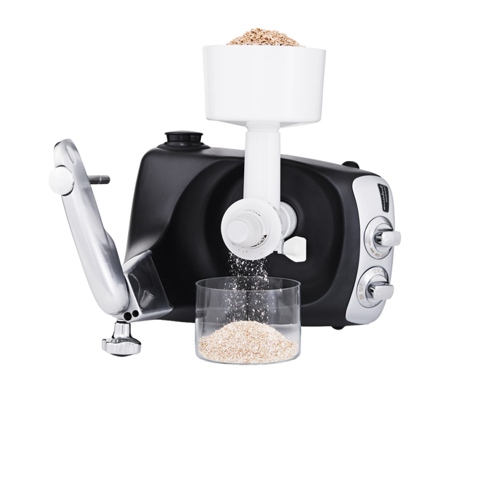 Black stand mixer with white grain mill attachment grinding fresh oats into a clear container on a clean surface, ideal for Kitchen & Food, Baking Supplies, Grain Mills, and Cooking Helpers collections.