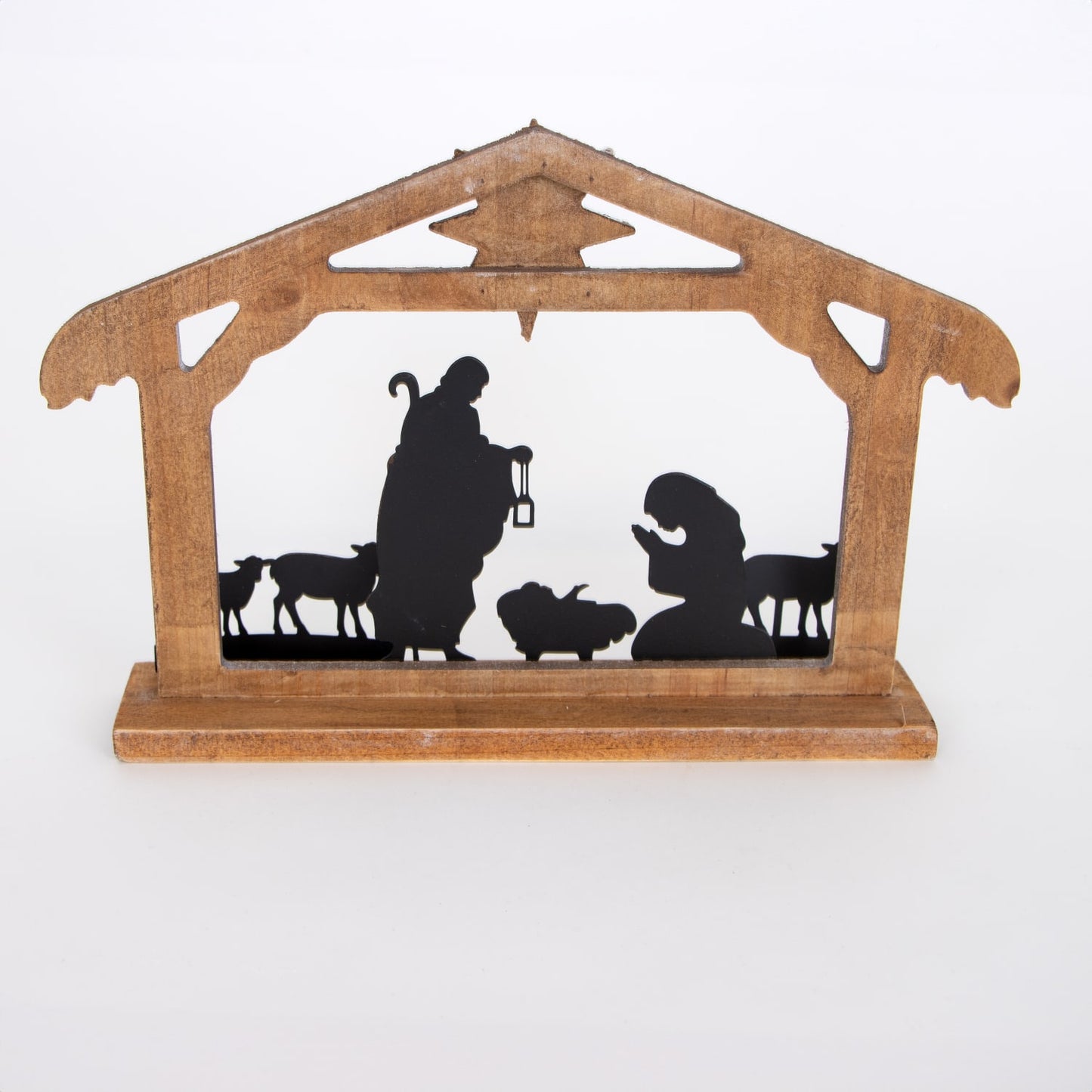 Wooden nativity display with metal silhouettes of the Holy Family and animals in a weathered stable, featuring a vintage style for Home & Decor and Holiday collections.