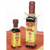 Two glass bottles of rich vanilla extract with decorative yellow and red labels, placed on a red checkered cloth, ideal for Kitchen & Food and Pantry collections.