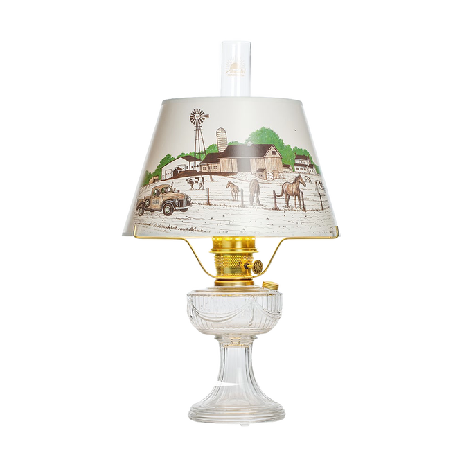 Handcrafted clear glass oil lamp with brass burner and decorative Lincoln Drape shade featuring a vintage farm scene, part of Lamps & Lighting, Oil Lamps, Table Lamps, Best Sellers, and Promo Eligible collections.