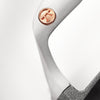 Close-up of a handcrafted cast iron pizza iron handle featuring a copper rivet with a distinctive emblem, part of Kitchen & Food, Cookware, Cast Iron, and Best Sellers collections.