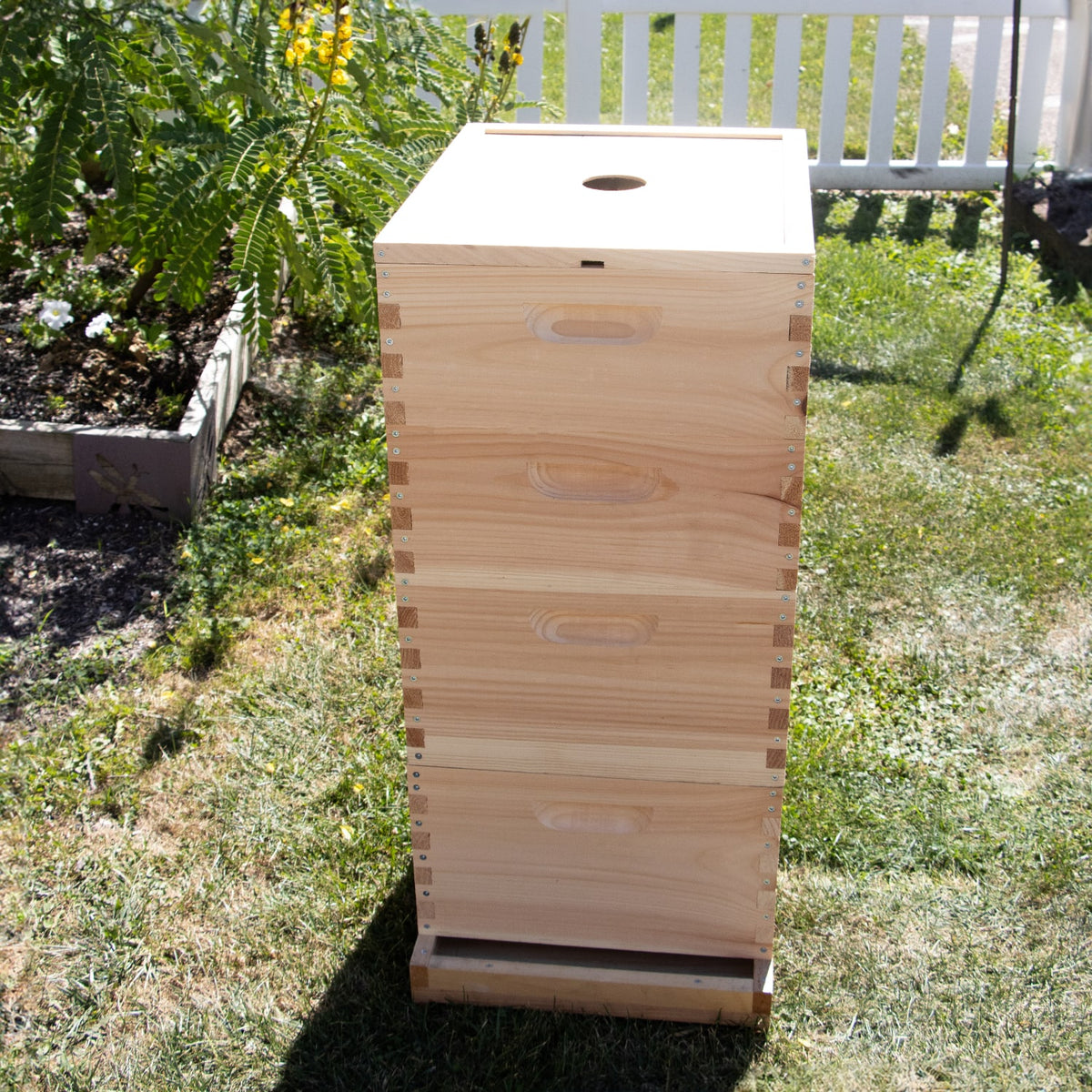Handcrafted Amish made 10-frame hive box with a notched inner cover featuring center ventilation hole, designed for moisture control and airflow in beekeeping, USA made.