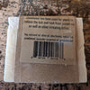Handcrafted soap bar wrapped in natural brown paper packaging, listing ingredients like jewelweed and lavender essential oil, promoting health and wellness in USA made collections.