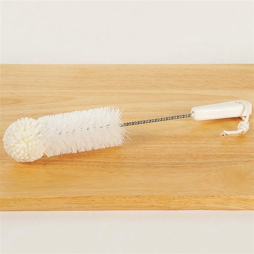 Cleaning brush with white foam tip, twisted wire handle, and a white plastic grip with hanging loop, suitable for household cleaning and USA made collections