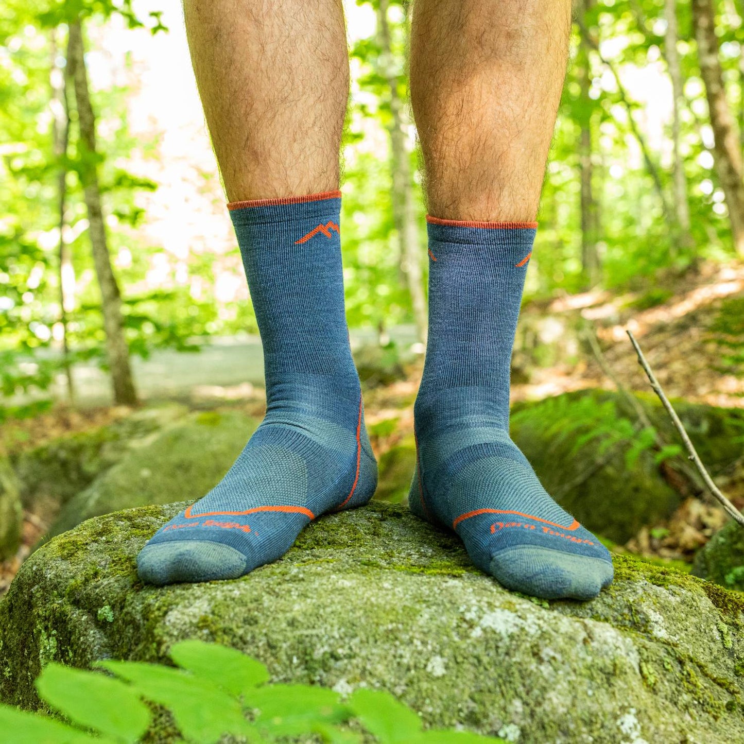 Pair of men's breathable light hiker crew socks in blue with orange highlights, shown outdoors on a mossy rock, suitable for Camping, Health & Wellness, and Clothing and Accessories collections.