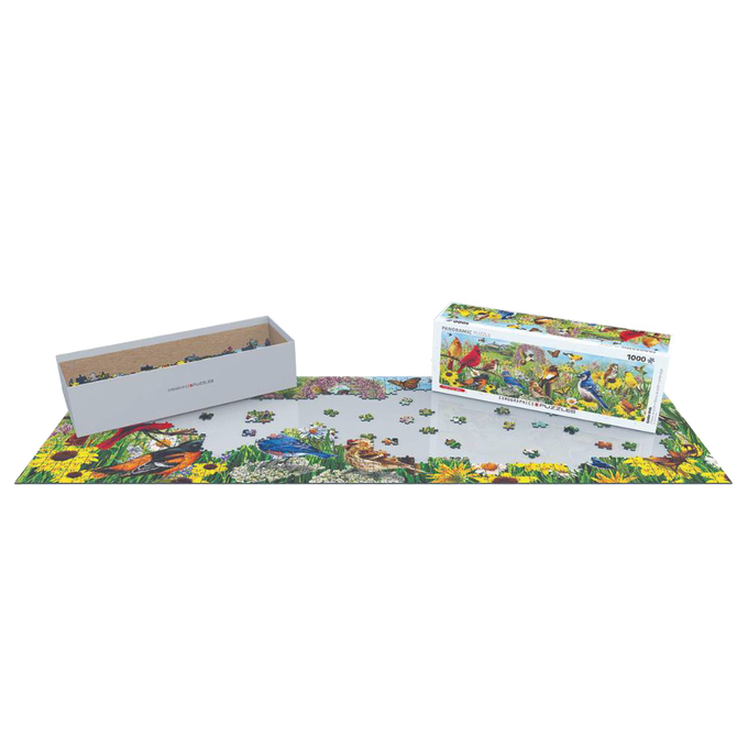 Partially completed 1000-piece puzzle featuring a colorful backyard bird scene with scattered pieces, accompanied by the puzzle box and a gray storage tray, part of Toys, Books & Games and USA Made collections.