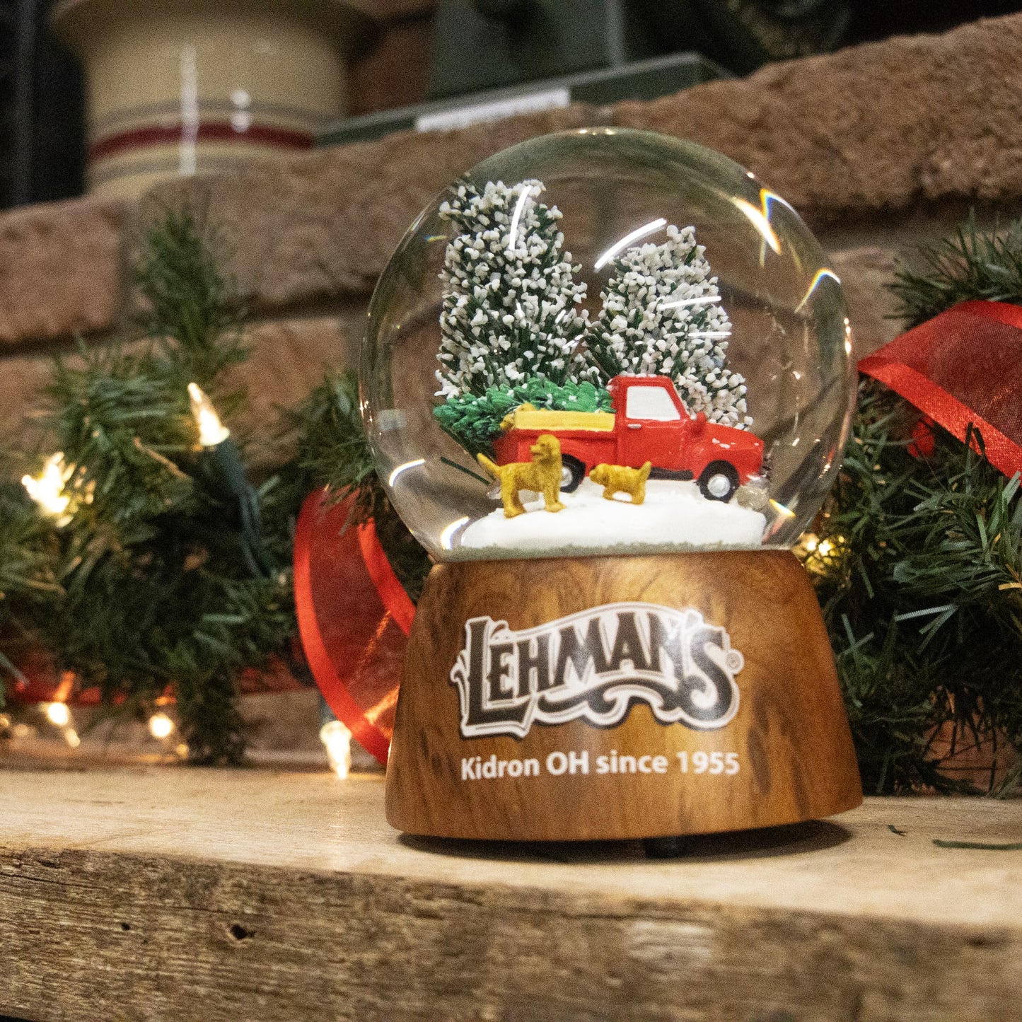 Handcrafted musical snow globe featuring a red truck with a Christmas tree and two dogs in a snowy scene, perfect for Home & Decor, Holiday Decor, and Best Sellers.