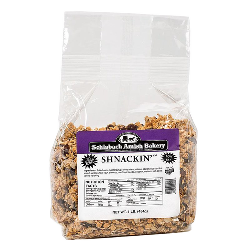 Clear resealable bag of handcrafted Shnackin granola with label showing nutrition facts and ingredients, featuring almonds, walnuts, sunflower seeds, coconut, and raisins, made in USA for Kitchen & Food, Snacks and Sweets, Dry Goods and Mixes, Best Sellers, and Promo Eligible collections.