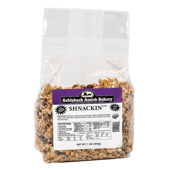 Clear resealable bag of handcrafted Shnackin granola with label showing nutrition facts and ingredients, featuring almonds, walnuts, sunflower seeds, coconut, and raisins, made in USA for Kitchen & Food, Snacks and Sweets, Dry Goods and Mixes, Best Sellers, and Promo Eligible collections.