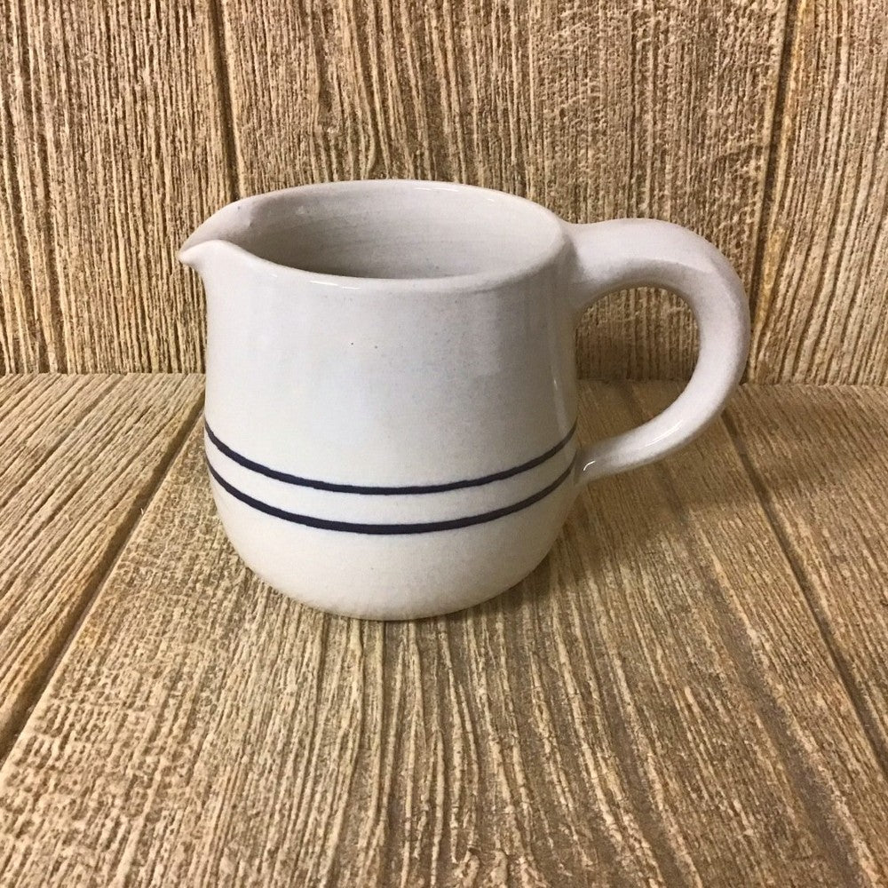 Handcrafted stoneware creamer with blue stripe design and rounded handle, made in USA, perfect for Kitchen & Food, Storage and Serving, Best Sellers, and Promo Eligible collections.