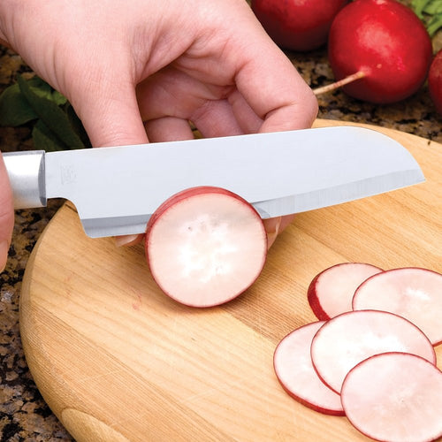Handcrafted utility knife with a sharp stainless steel blade slicing radishes on a wooden cutting board, ideal for food prep in kitchen, farm, and garden settings.